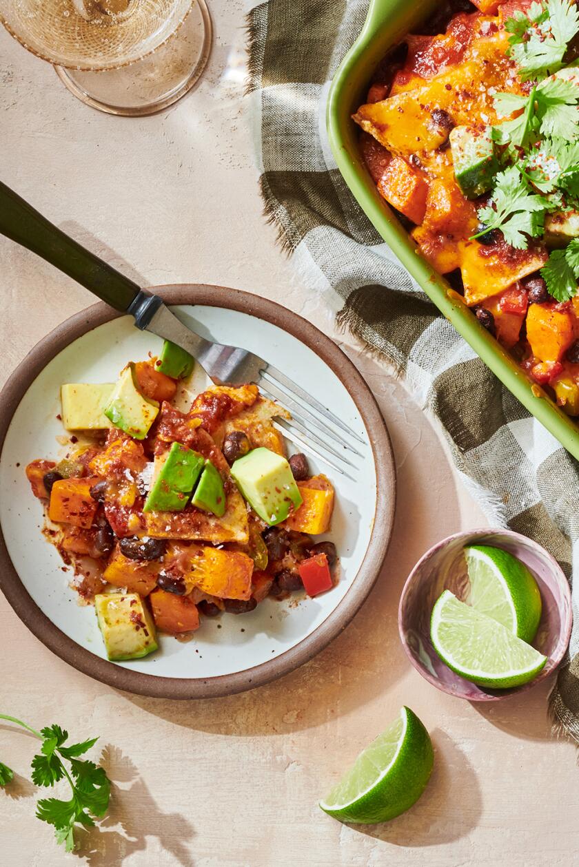 VEGGIE ENCHILADA Casserole dish styled on a light colored surface
