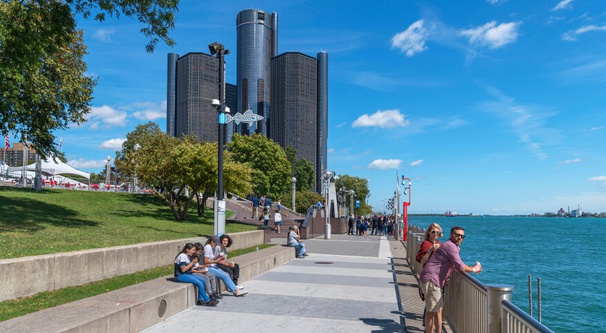 People enjoying the Detroit River Walk on a sunny day in Detroit, Michigan.