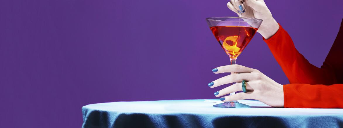 woman's hands holding a martini glass