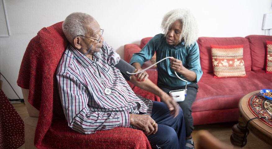 image_of_woman_taking_mans_blood_pressure_GettyImages-1176515533_1800