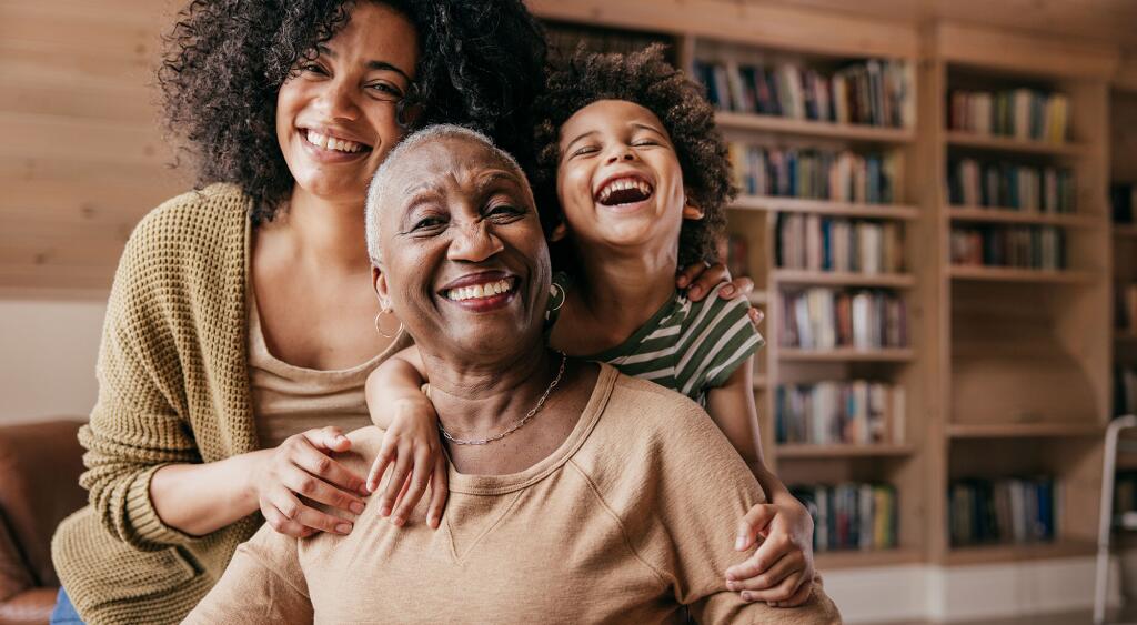 Woman posing with daughter and grandmother