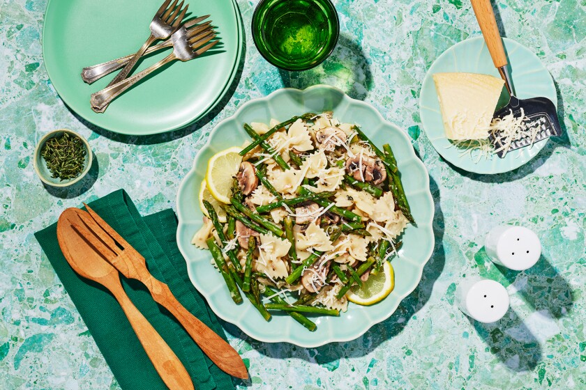 Asparagus Mushroom Pasta with green plates and marbled background