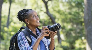 image_of_woman_holding_camera_outside_GettyImages-1049506008_1800