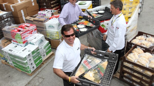 Volunteers collect food from Daytona Speedway Monday.