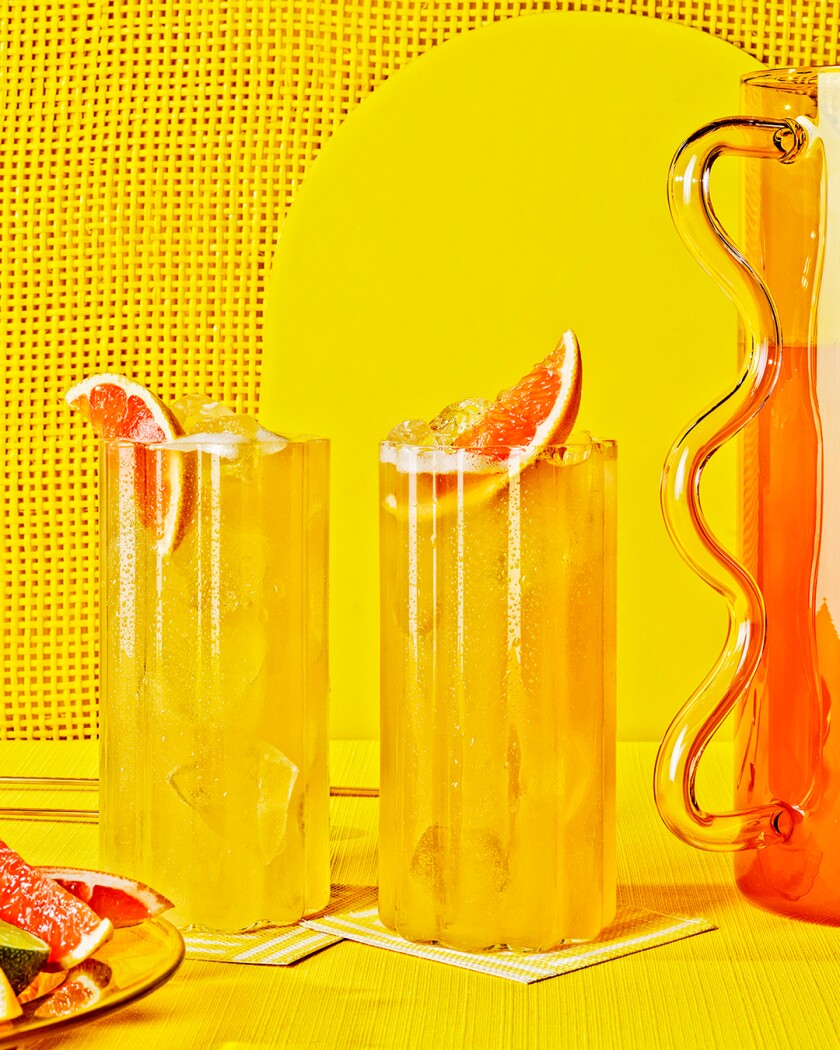 Paloma cocktails on bright yellow background 