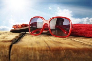 Summer Glasses on wood with towel and slippers