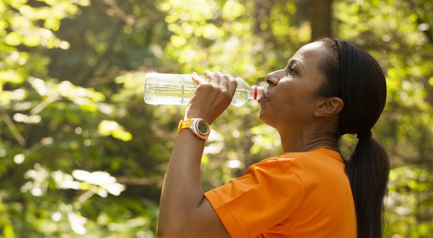 image_of_woman_outside_drinking_water_bottle_GettyImages-647249888_1800