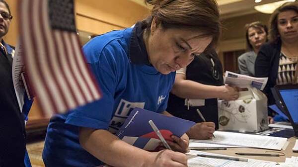 Caucusgoers check-in before casting their vote for a Democratic presidential candidate ahead of the Nevada Democratic presidential caucus at Caesar's Palace in Las Vegas, Nevada, U.S., on Saturday, Feb. 20, 2016. Today voters weigh in on the Democratic battle between Hillary Clinton and Bernie Sanders competing in the Nevada caucuses with Clinton believed to have the advantage in the western state because of its heavily Hispanic electorate, but some recent polls show the race tied.