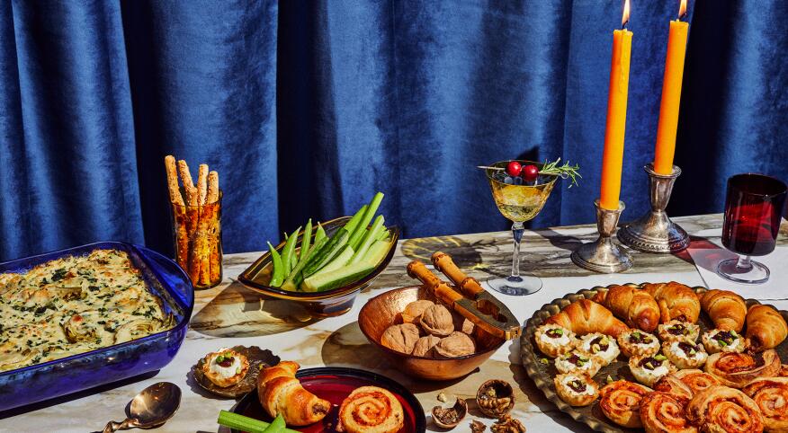 Four appetizers on a decorated table set for the winter holidays