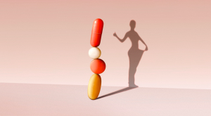 photo illustration of weight loss pills forming a human silhouette shadow on wall