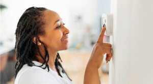 Woman checking thermostat