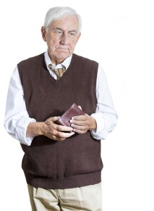 Older man cautiously holiding his wallet