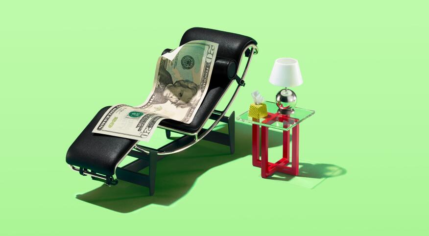 A 20 dollar bill sitting in a tiny therapist chair with a lamp and tissues