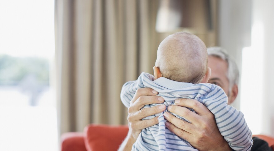 Man lifting baby