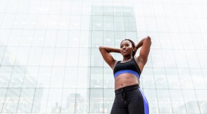 A photo of a woman in fitness gear, posing to show off her curves.
