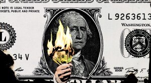 George Washington on one US dollar with sad expression holding a burning $100 bills