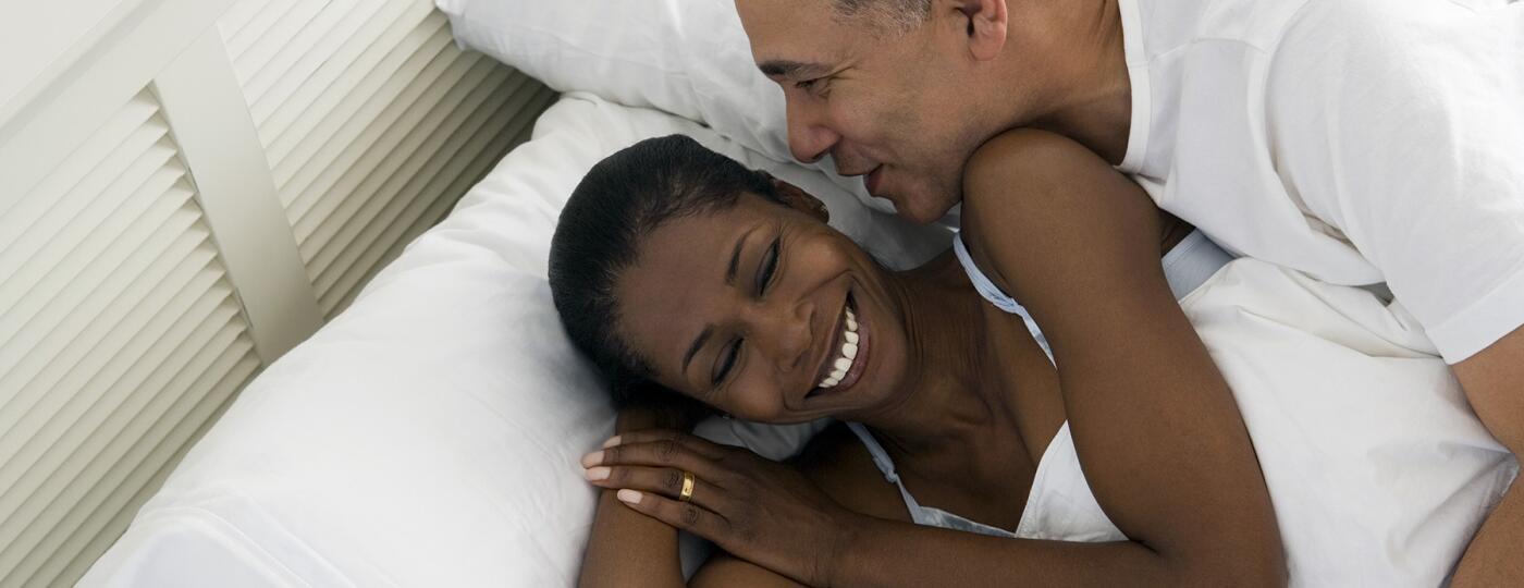 image_of_man_and_woman_in_bed_laying_on_pillows_GettyImages-73772548_1800
