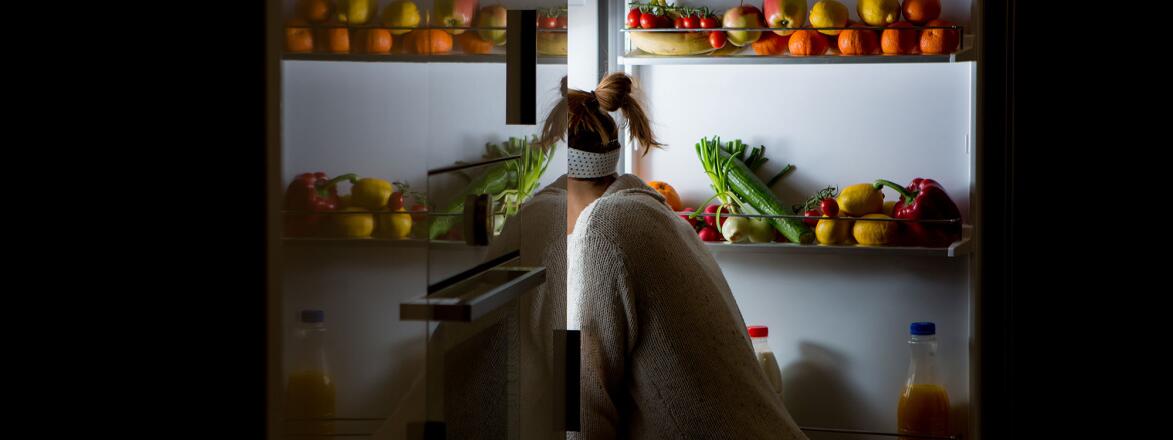 Woman looking in fridge for midnight snack