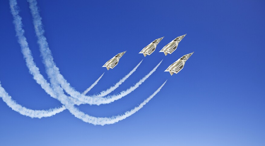 image_of_dollar_bill_paper_airplanes_flying_through_sky_GettyImages-157506556_1800