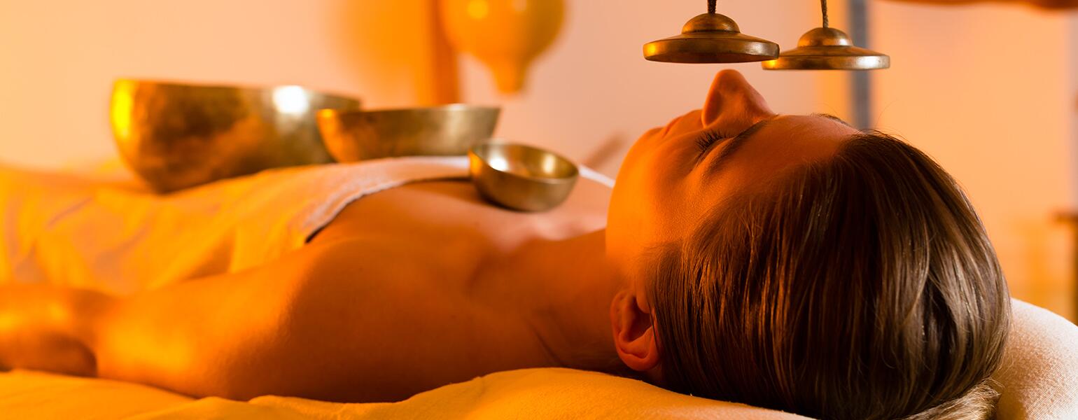 Woman at Wellness massage with singing bowls