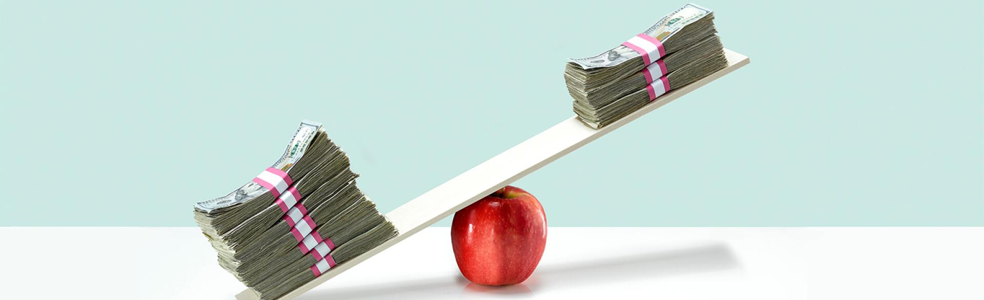 image of money on balance scale on top of apple