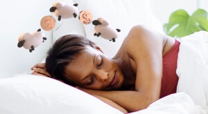 photo_illustration_of_women_sleeping_with_sheep_and_coins_over_her_head_GettyImages-1169337479_illo_by_simoul_alva_612x386