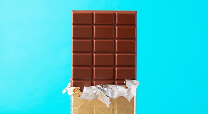 photo of chocolate bar on light blue background