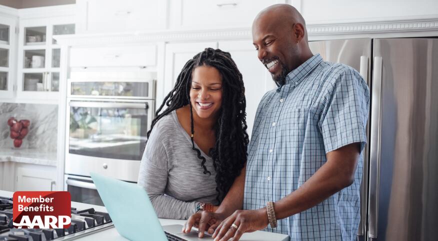 Couple looking at a laptop at home
