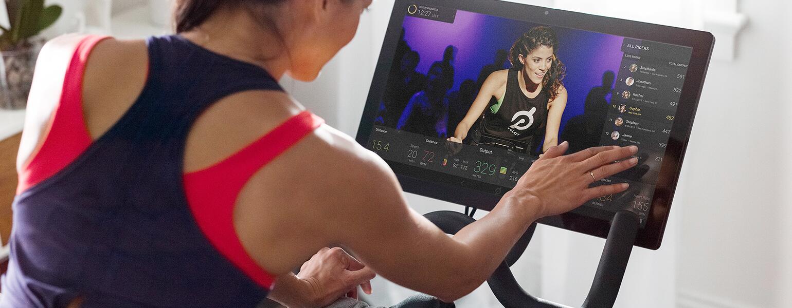An image of a woman cycling during a Peloton class.