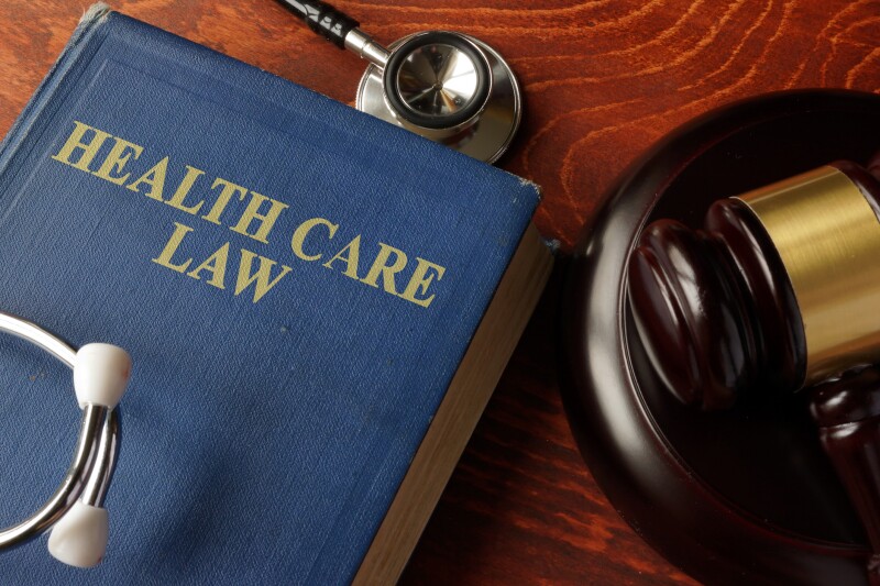 Book with title Health Care Law on a table.