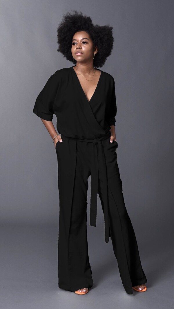 A female black model wears the Black Gail Jumper by Tracy Nicole
