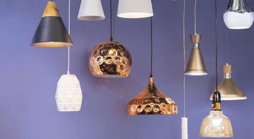 Variety of modern chandeliers on purple background.