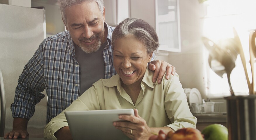 Couple reviewing a document on a digital tablet together