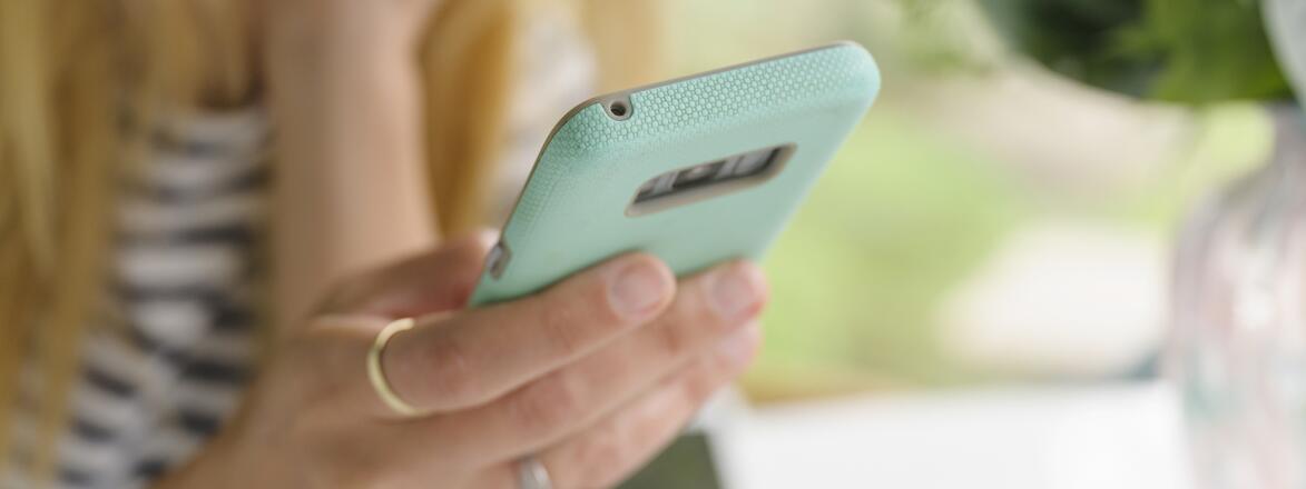 upset woman looking at her phone