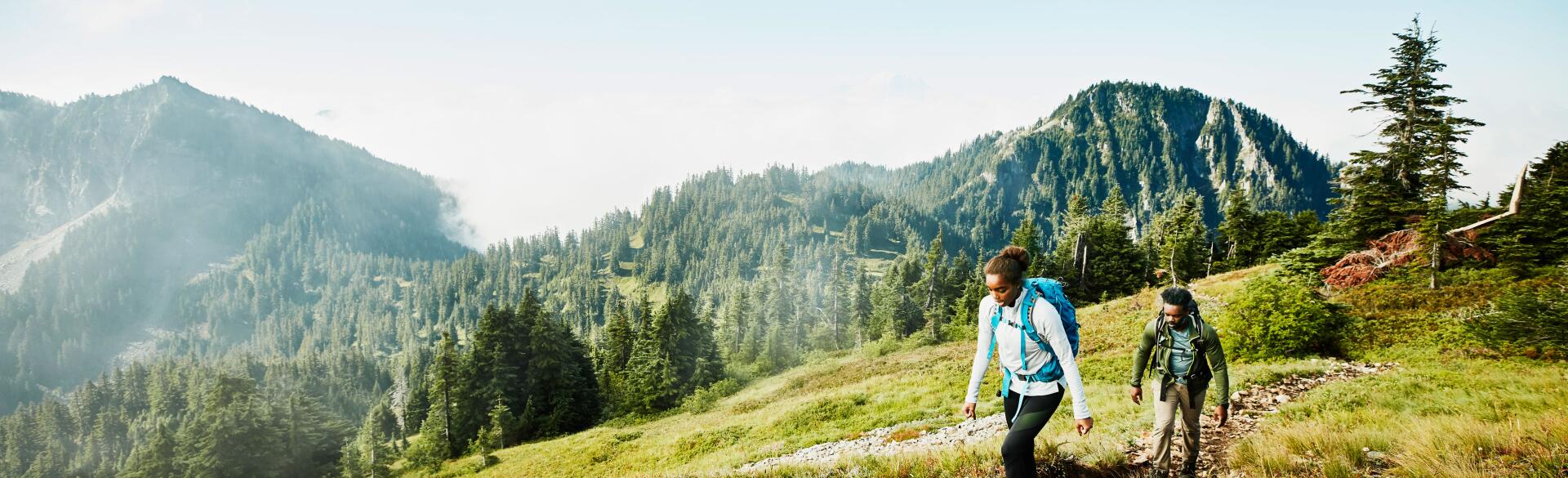 Female and male hiking in the mountains