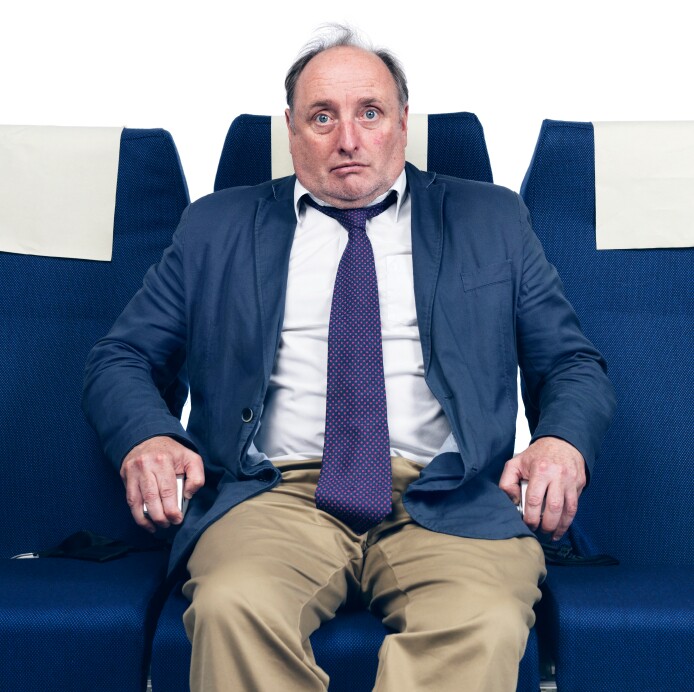 Worried man in airplane seat