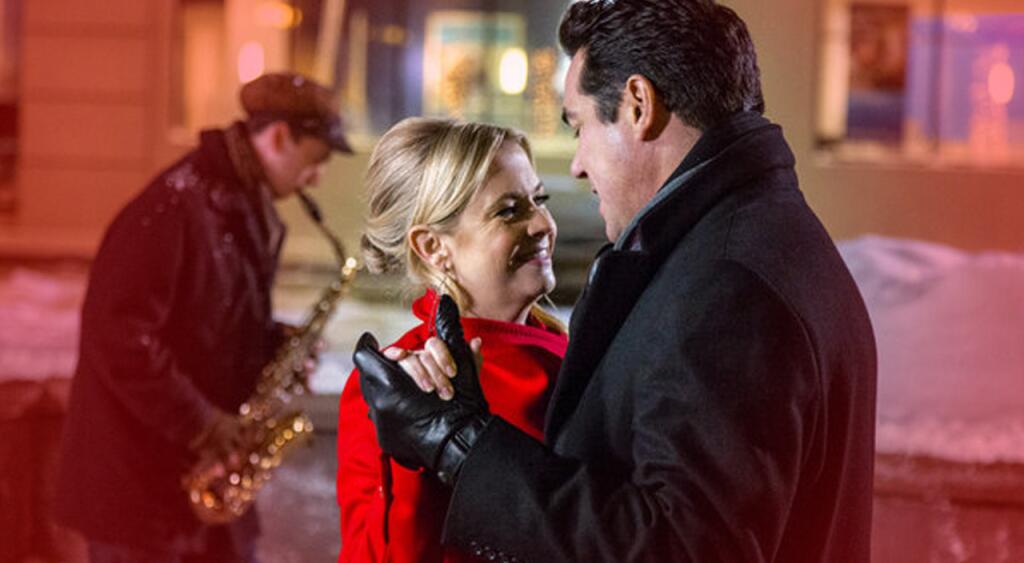 Movie still of Melissa Joan Hart and Dean Cain dancing from Hallmark's "Broadcasting Christmas"