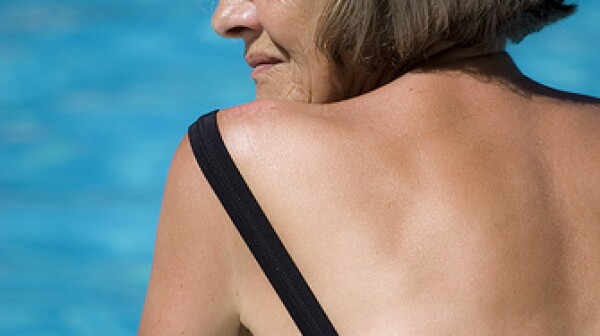 Profile of a beautiful older woman at a swimming pool