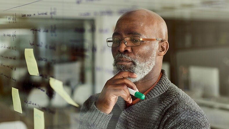 Older Black male professional working on strategic issue