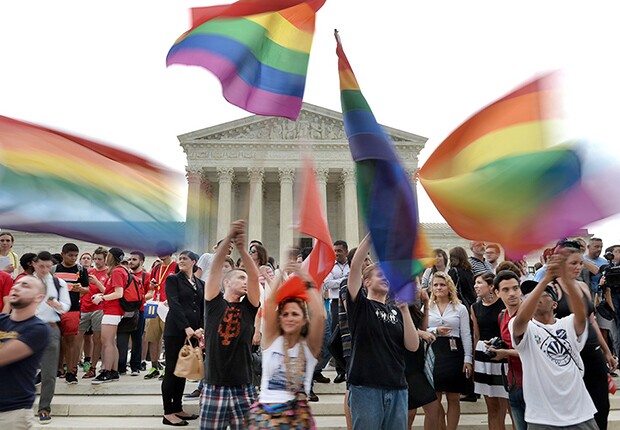 Married couple John Lewis, left, and Stuart Gaffney, of San Francisco, hold heart signs outside the U.S. Supreme Court before the start of oral arguments on marriage equality on Tuesday, April 28, 2015. Lewis and Gaffney were plaintiffs in the 2008 court case challenging California's same sex marriage ban.