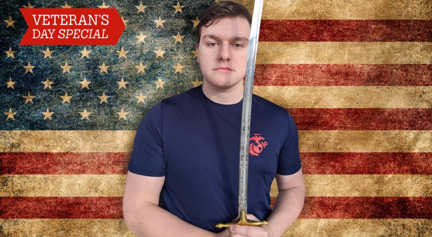 young man with sword standing in front of USA flag