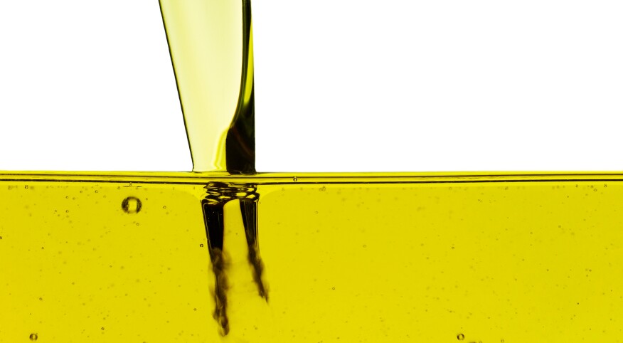 Yellow oil being poured into a container