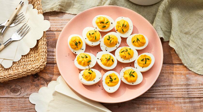 Platter of deviled eggs on light surface