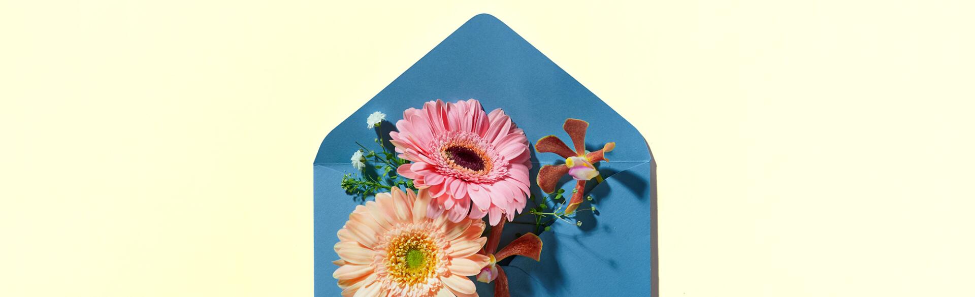 Blue Envelope Full Of Various Flowers.