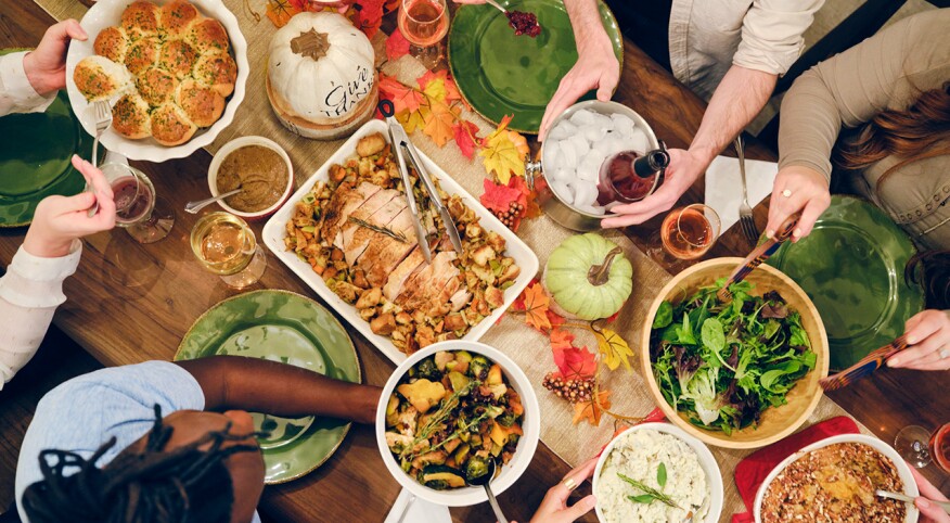 Overhead image of multiple people enjoying a Thanksgiving dinner