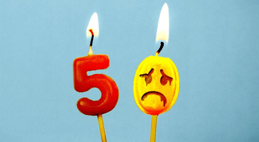 Birthday cake toppers of a 5 and a 0, appearing to melt away with sad face drawn on it