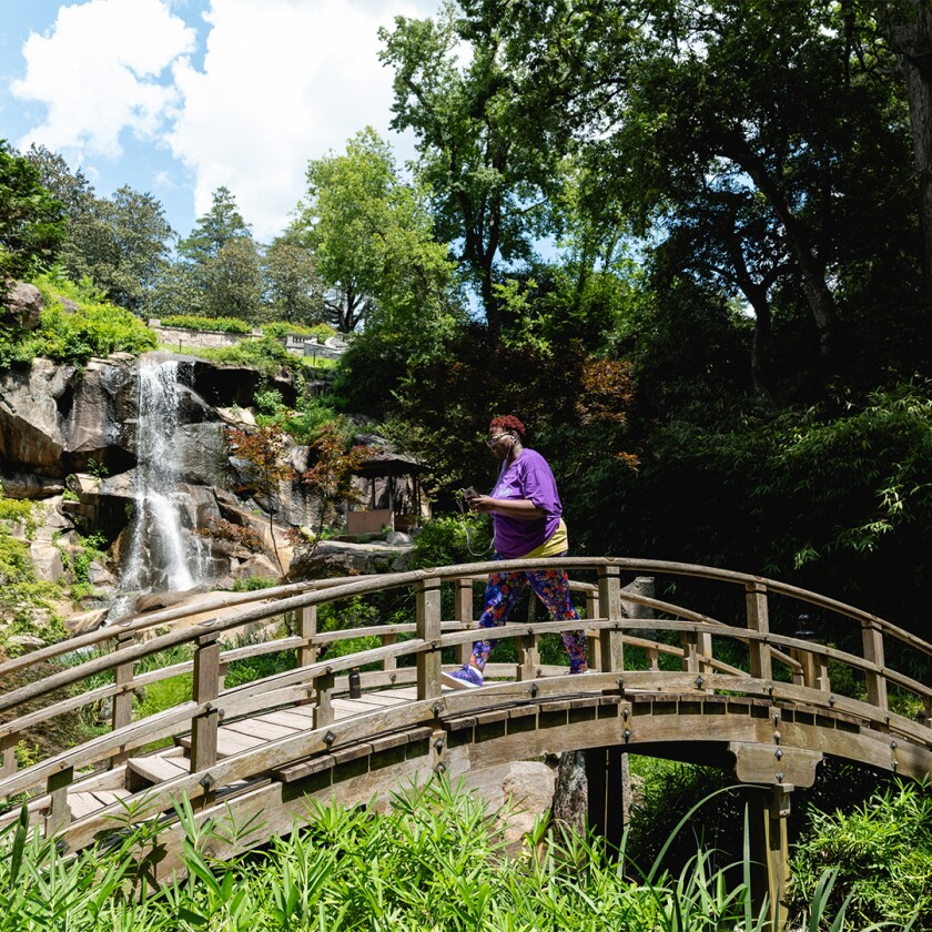 Sharon Mitchell exercising, walking across a bridge