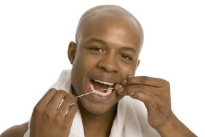 Man flossing teeth