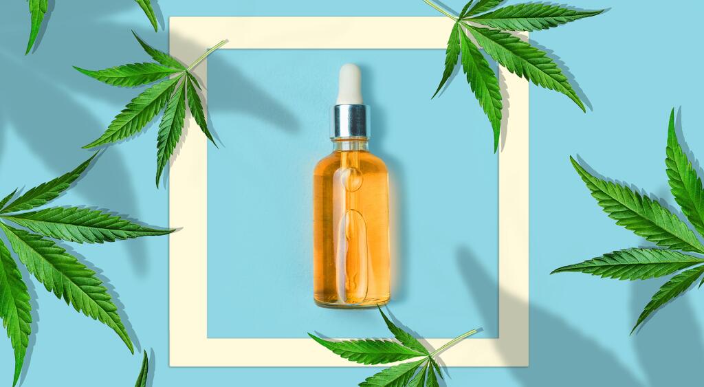cannabis leaves on a light blue background with a bottle CBD OIL