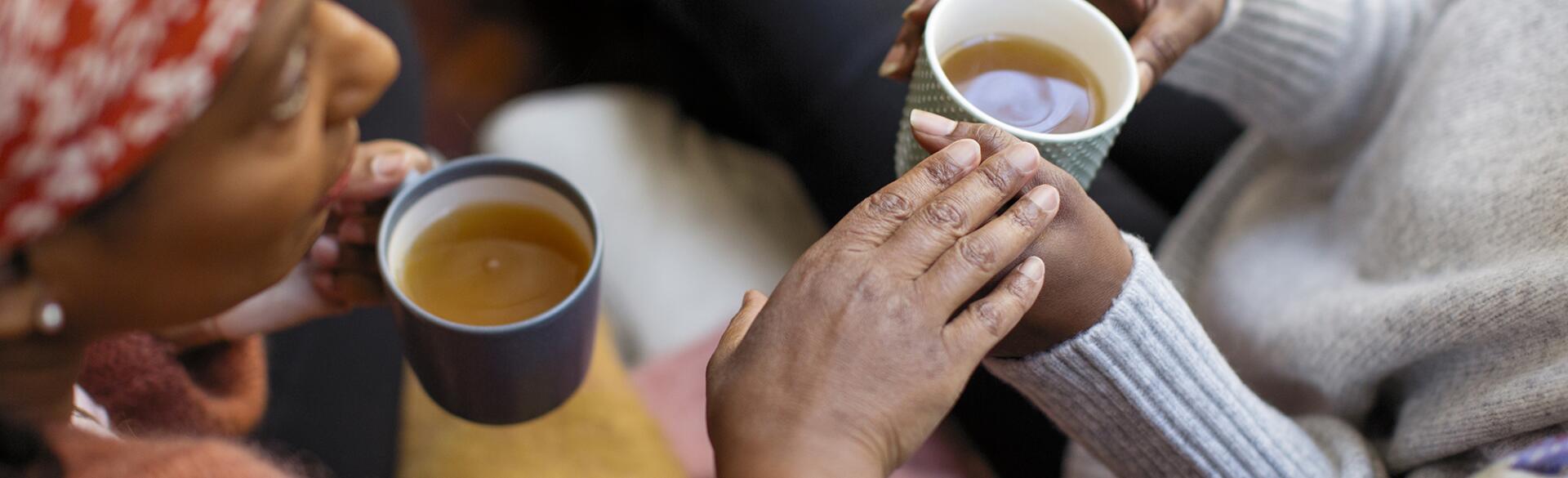 Women friends talking, drinking tea